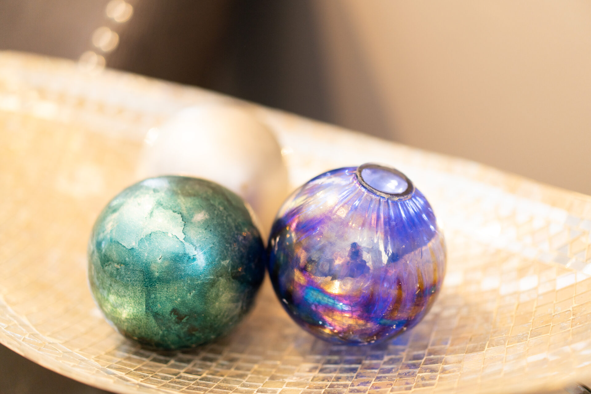 Two glass balls sitting on top of a table.
